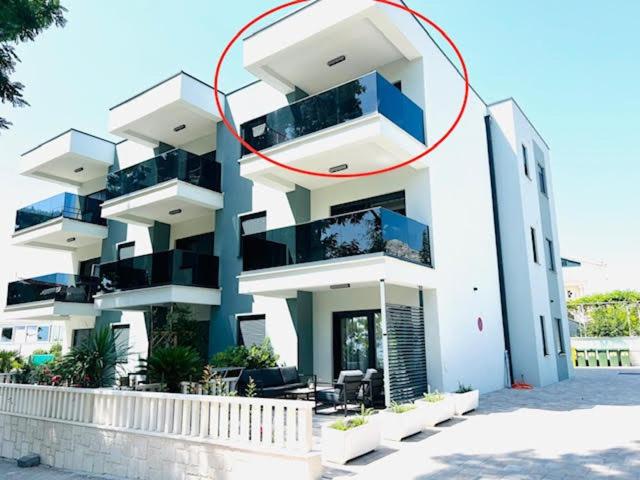 a large white building with a red circle on it at Apartment Marta in Orebić