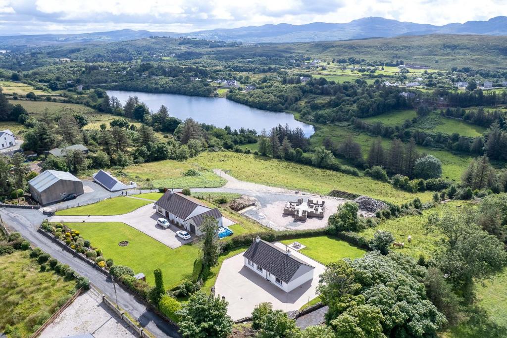 an aerial view of a large estate with a lake at Bradleys Cottage Creeslough in Creeslough