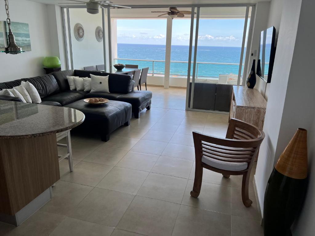 a living room with a couch and a table at Marbella Towers - Ocean Front in Juan Pedro