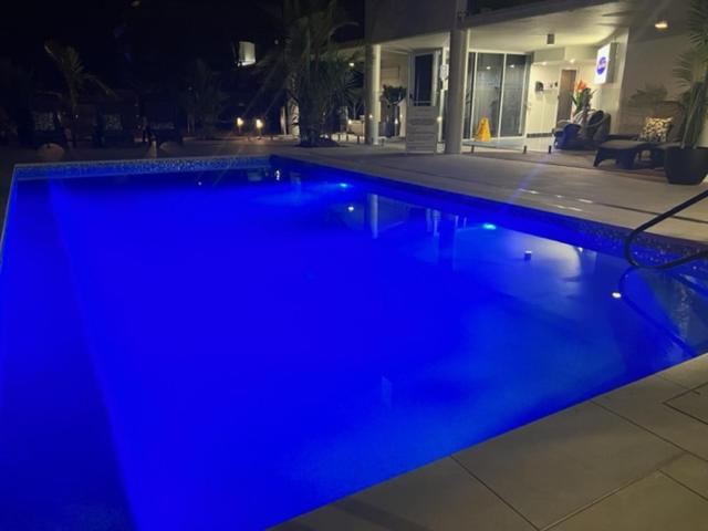 a swimming pool with blue lights in a house at Marina Terraces Port Douglas in Port Douglas