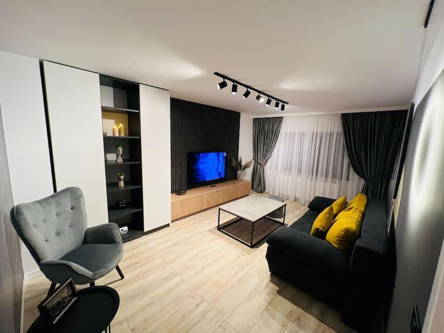 a living room with a couch and a television at Impact Apartments in Piteşti