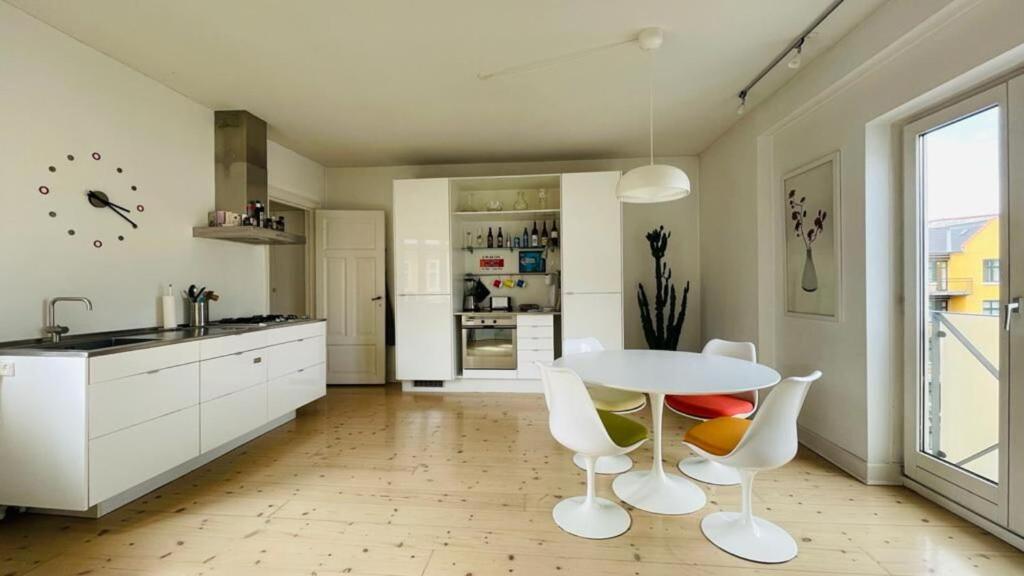 a kitchen with a table and chairs in a room at ApartmentInCopenhagen Apartment 664 in Copenhagen