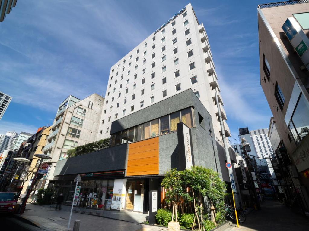 a building on a street in a city at Super Hotel Premier Akasaka in Tokyo