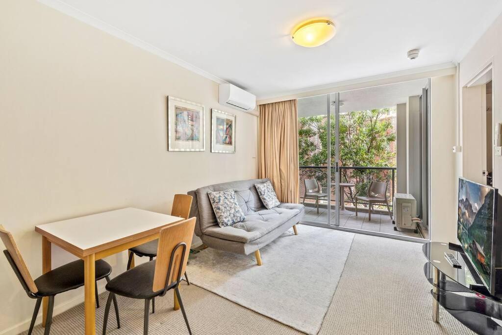 a living room with a couch and a table and chairs at Modern comfort Chippen119 Self Catering in Sydney
