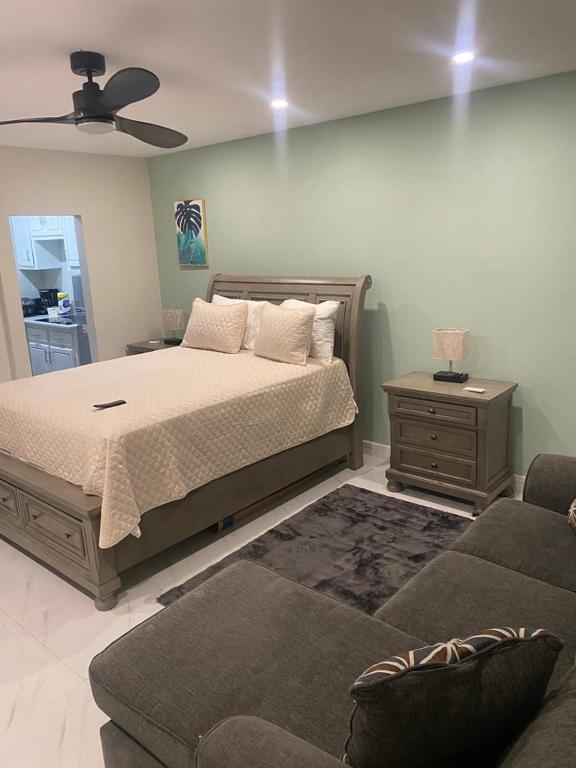 a bedroom with a bed and a couch at City View Luxury Home in Montego Bay