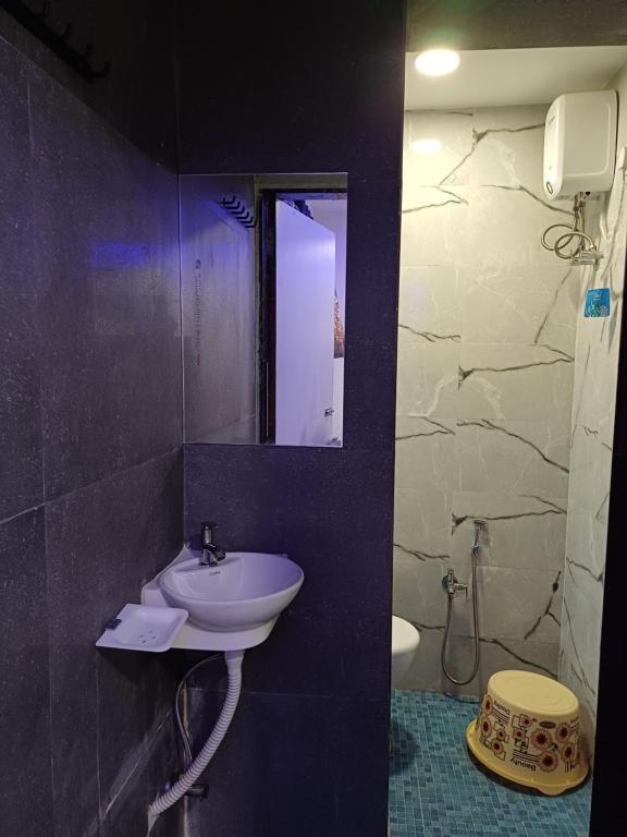 a bathroom with a sink and a mirror at HOTEL EAGLE INN, NARODA in Ahmedabad