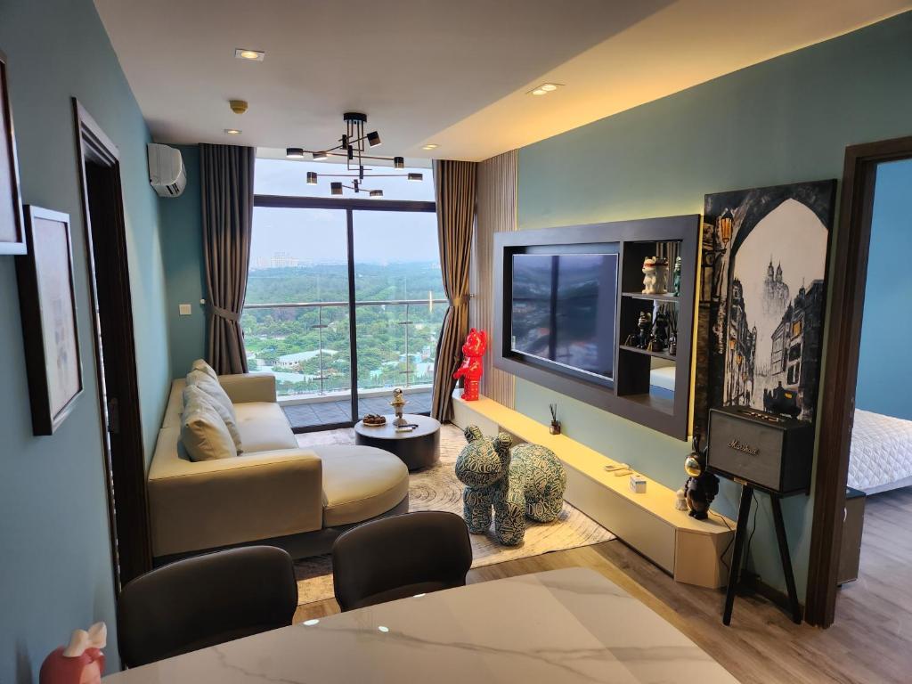 a living room with a couch and a tv at BEARBRICK homestay near beach, CSJ Tower Apartment Vung Tau in Vung Tau