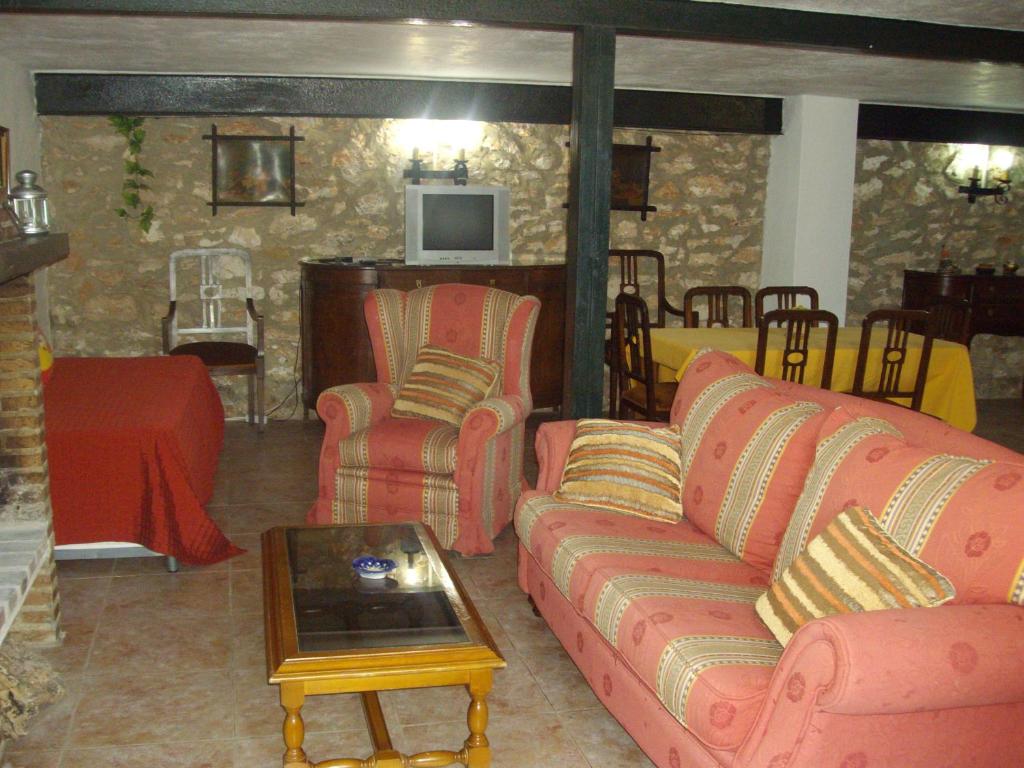 a living room with pink couches and a table at House No 02 median in Humilladero