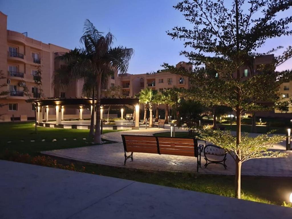 a park with a bench and trees and buildings at Luxury Aqua Tropical Resort Next To Al Gouna 4 0 1 in Hurghada