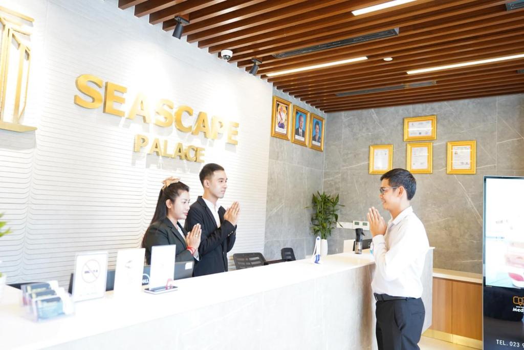 a group of people standing at a reception desk at Seascape Palace Hotel in Sihanoukville