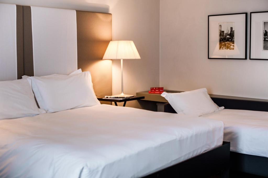 Postel nebo postele na pokoji v ubytování Hotel Casa Poli