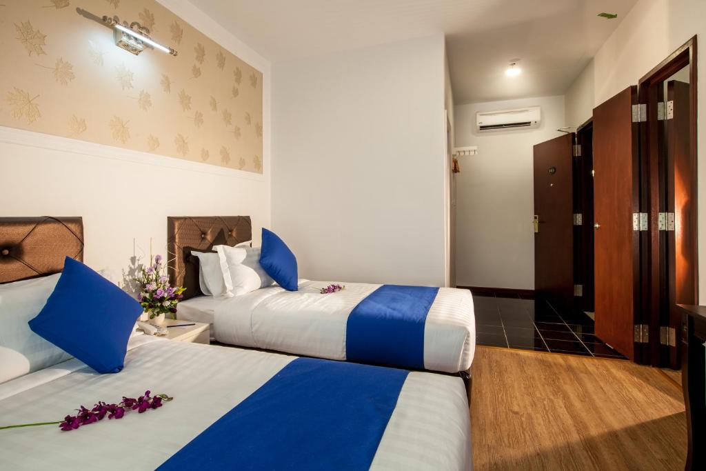 Postel nebo postele na pokoji v ubytování Koho Hotel - Johor Bahru