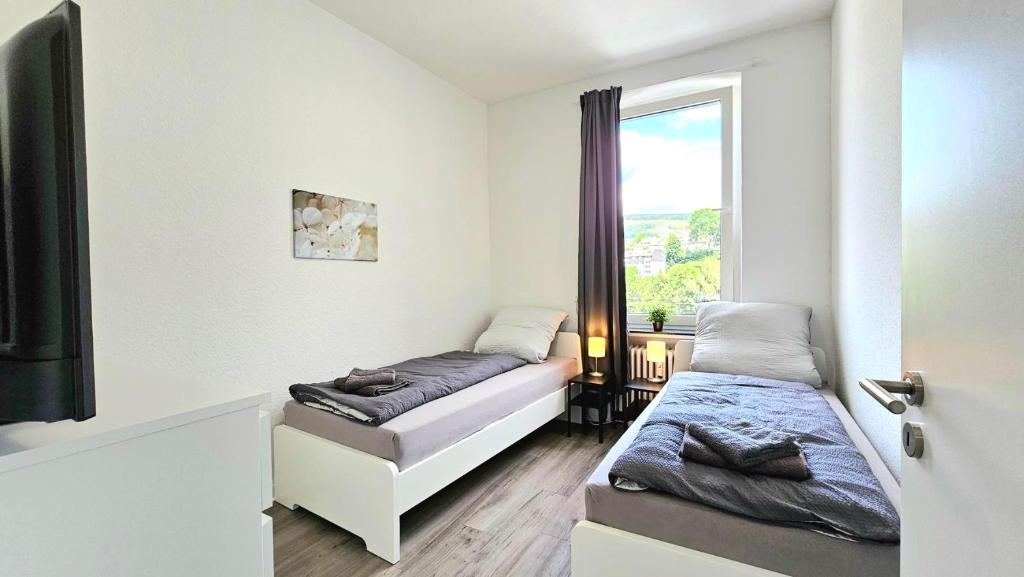 a bedroom with two beds and a window at Apartments in Altena in Altena