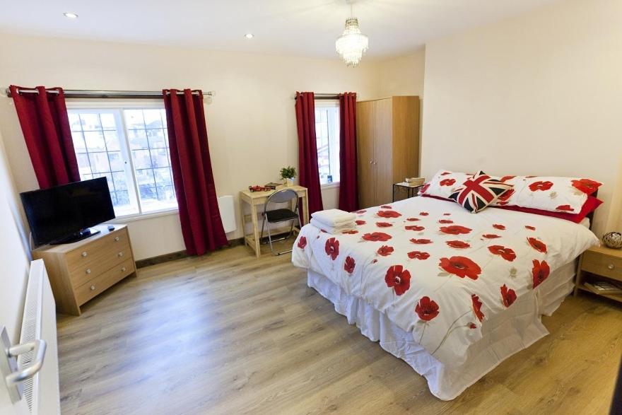 a bedroom with a bed and a television in it at Emporium Apartments - Nottingham City Centre - Your own 7 Bedrooms Apartment with 3 Bathrooms and full Kitchen - "Cook as you would at Home" - opposite Victoria Centre Shopping Centre - Outdoor Parking for Cars or Vans at five pounds a day in Nottingham