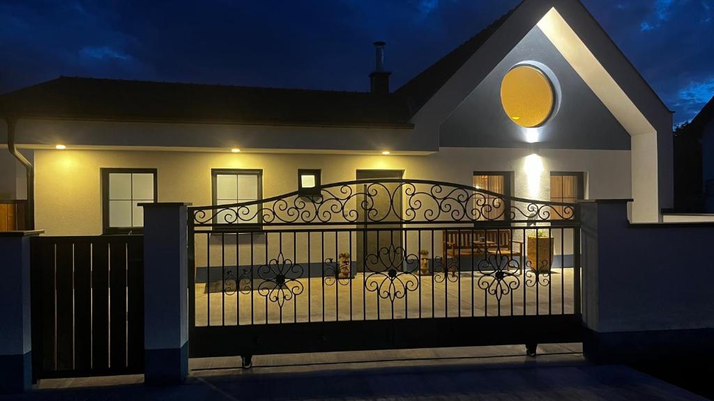 a house with a wrought iron gate at night at CHALET-KOPPI in Apetlon