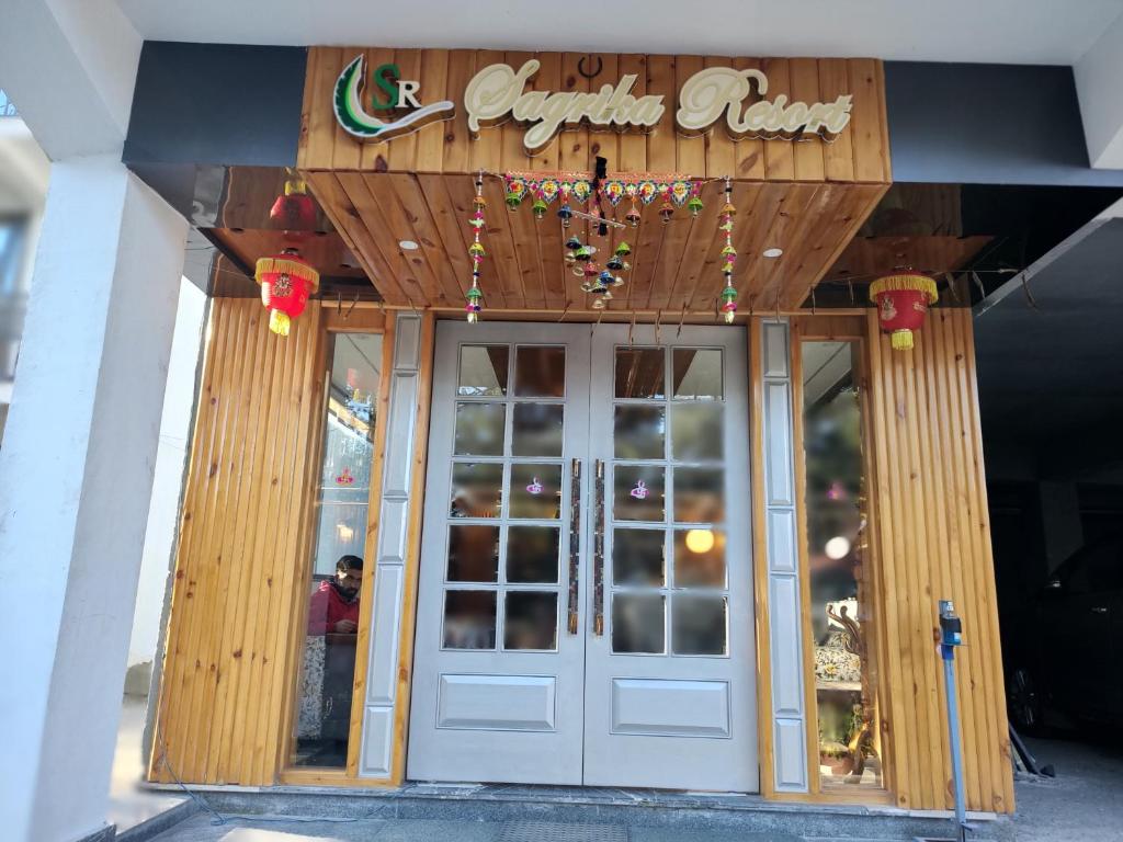 a front door of a restaurant with a sign above it at Sagrika Resort Dalhousie in Dalhousie