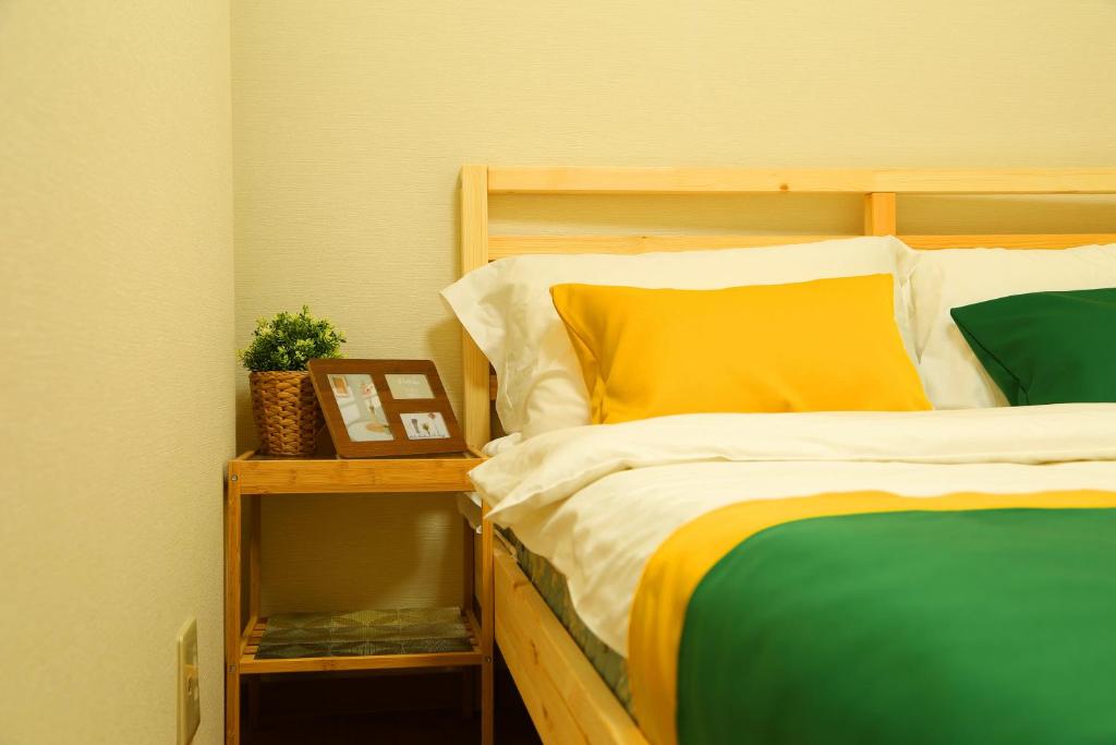 Postel nebo postele na pokoji v ubytování E JOY INN-West Shinjuku Branch