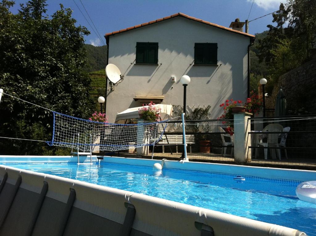 a swimming pool in front of a house at Dolcevia in Levanto
