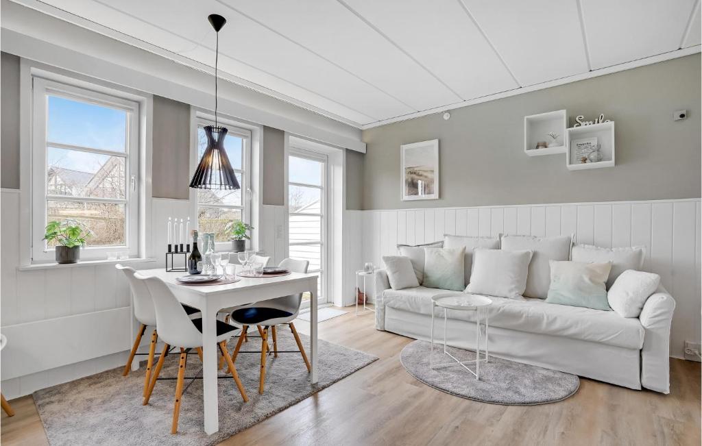 a living room with a white couch and a table at Lejlighed 25 in Sønderby