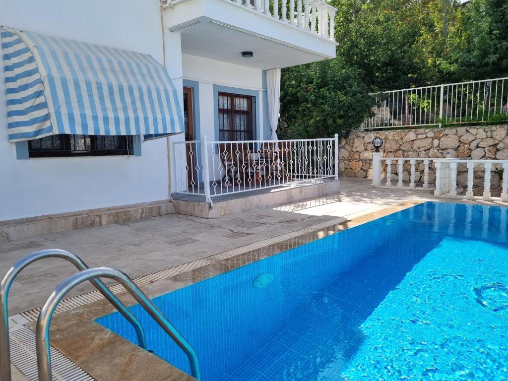 a swimming pool in front of a house at Kalkan Centre Bijou Home - Walk to town and beach in Kalkan