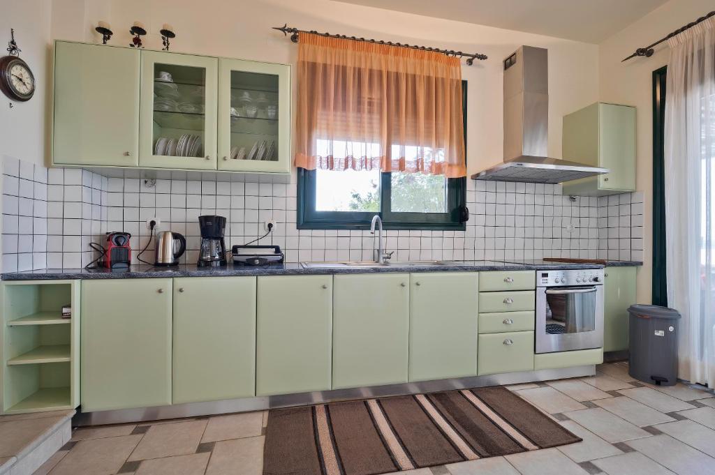 A kitchen or kitchenette at Marisia Apartment