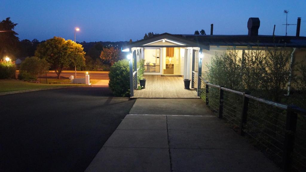 a small house at night with a driveway at Armidale Inn in Armidale