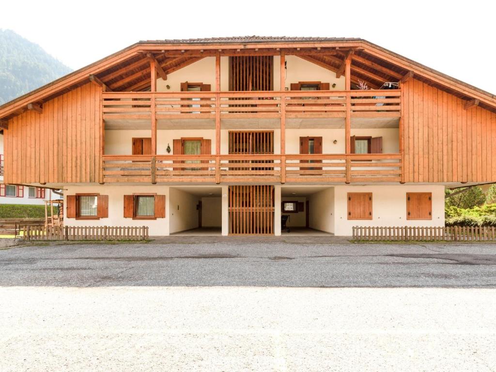 a large wooden building with a balcony at Spacious Chalet with Garden near Ski Area in Tyrol in Pozza di Fassa