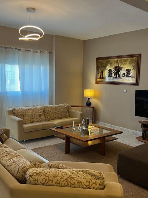 a living room with a couch and a coffee table at Elaia Apartment in Kavála