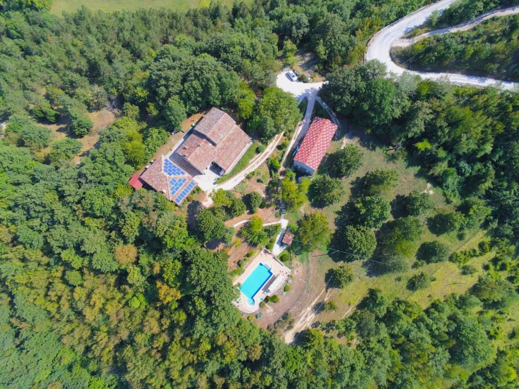 an aerial view of a house with a swimming pool at Country Cottage in Marche with Swimming Pool in Apecchio
