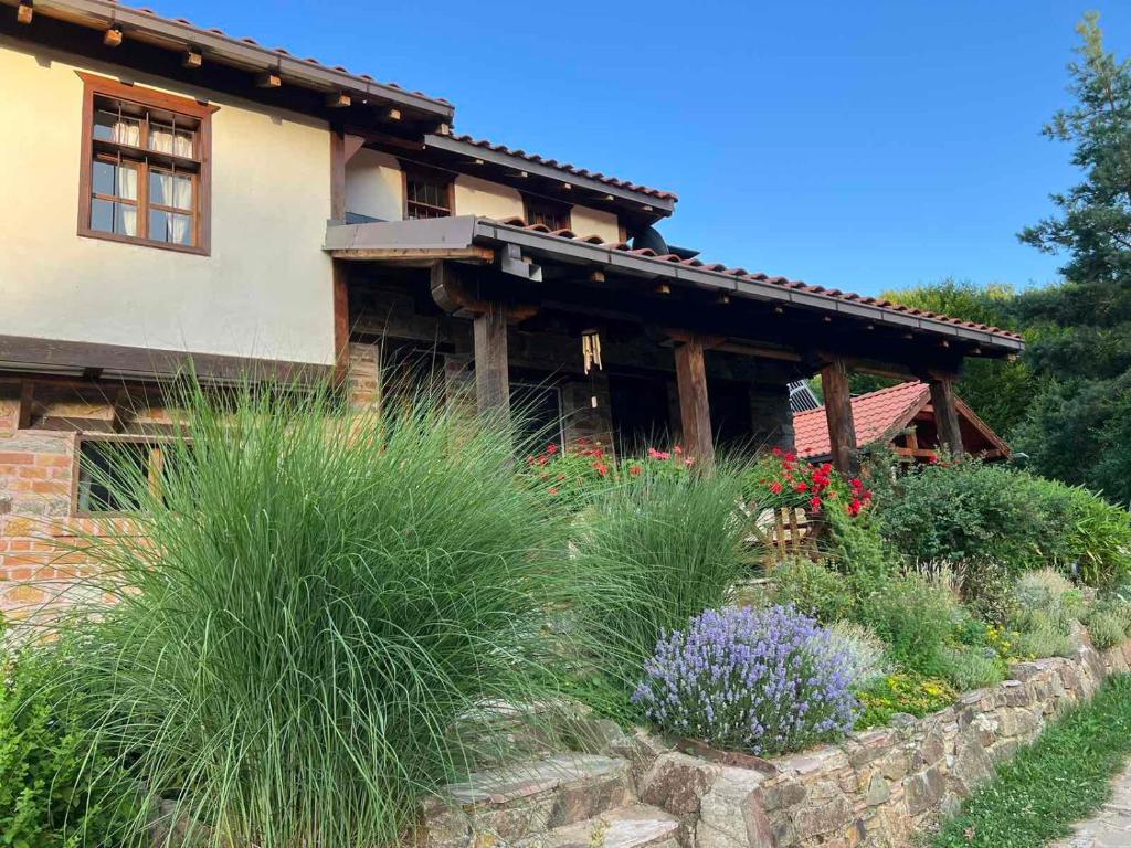 a house with a garden in front of it at Traditional Cottage - Vila Samovila in Delčevo