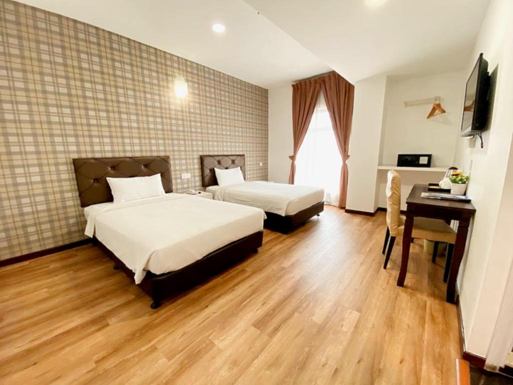 Postel nebo postele na pokoji v ubytování Koho Hotel - Johor Bahru