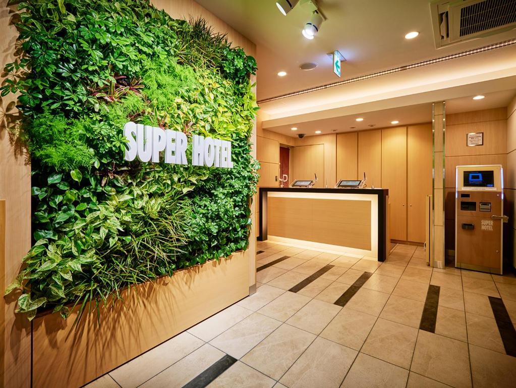 an office lobby with a green wall at Super Hotel Akihabara Suehirocho in Tokyo
