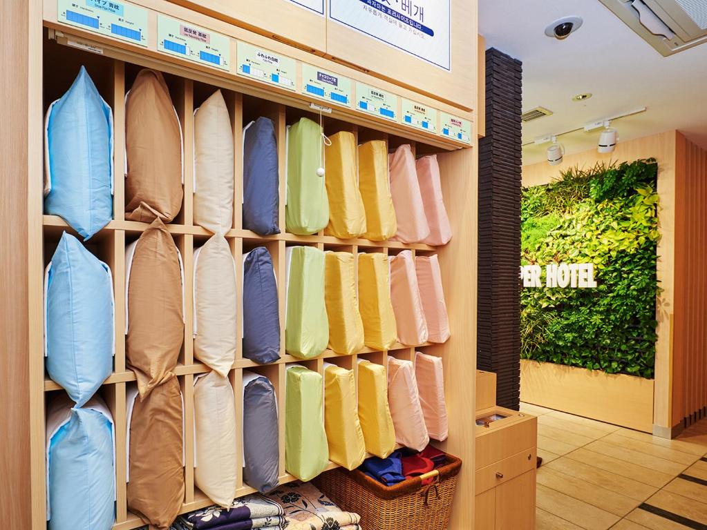 a closet filled with lots of different colored shirts at Super Hotel Akihabara Suehirocho in Tokyo