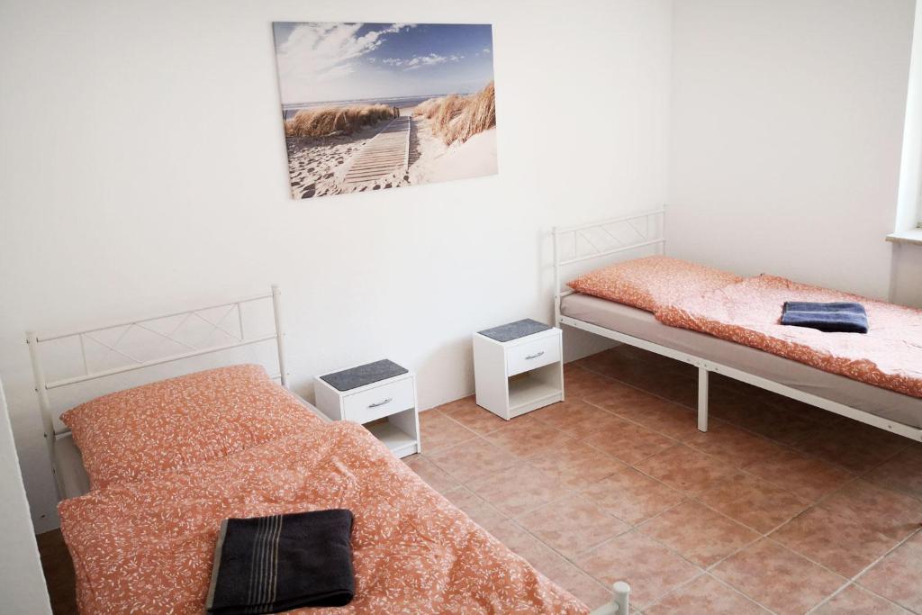 a room with two beds and a picture on the wall at Boardinghouse in Mörfelden-Walldorf in Mörfelden-Walldorf