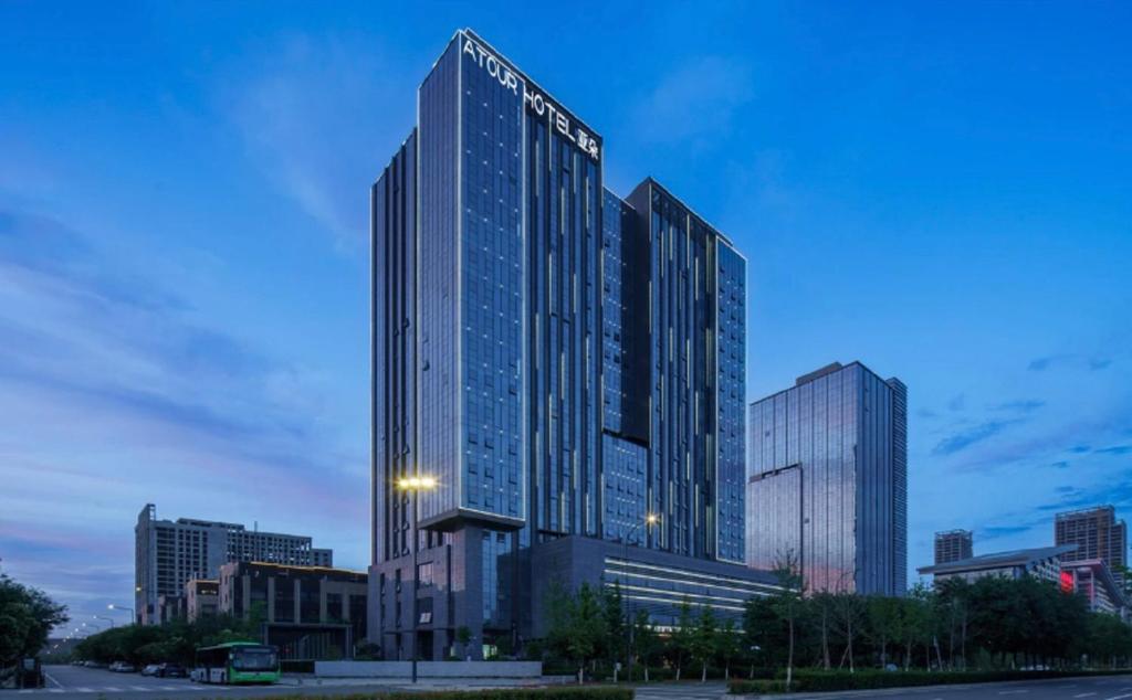 a tall building with a sign on the side of it at Atour Hotel Xi'an Fengdongsi Road Center in Chang'an