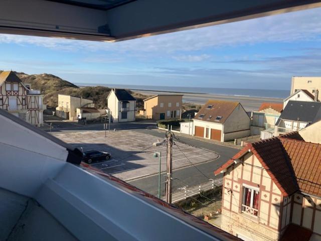 a view from a window of a town with a parking lot at Baie de Somme, Quend-Plage, 50m de plage, appart 4 a 6 personnes in Quend