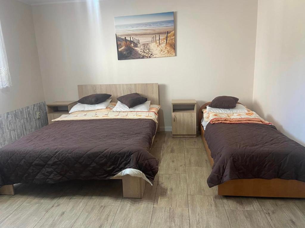 two beds sitting next to each other in a bedroom at Willa Perła Morza in Władysławowo