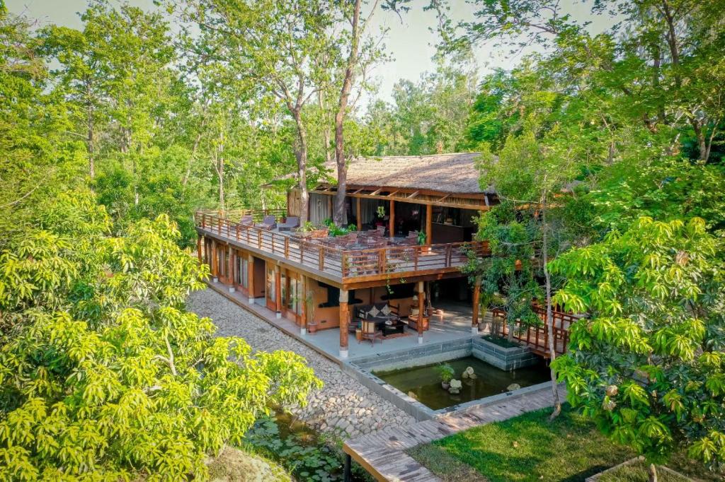 an aerial view of a house in the forest at Miraaya Wellness and Golf Resort in Chitwan