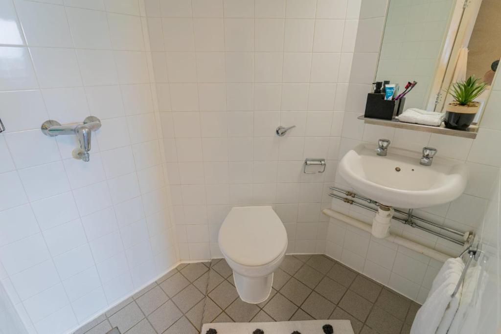 a bathroom with a toilet and a sink at Cosy Studios at New Hall located in the heart of Nottingham in Nottingham