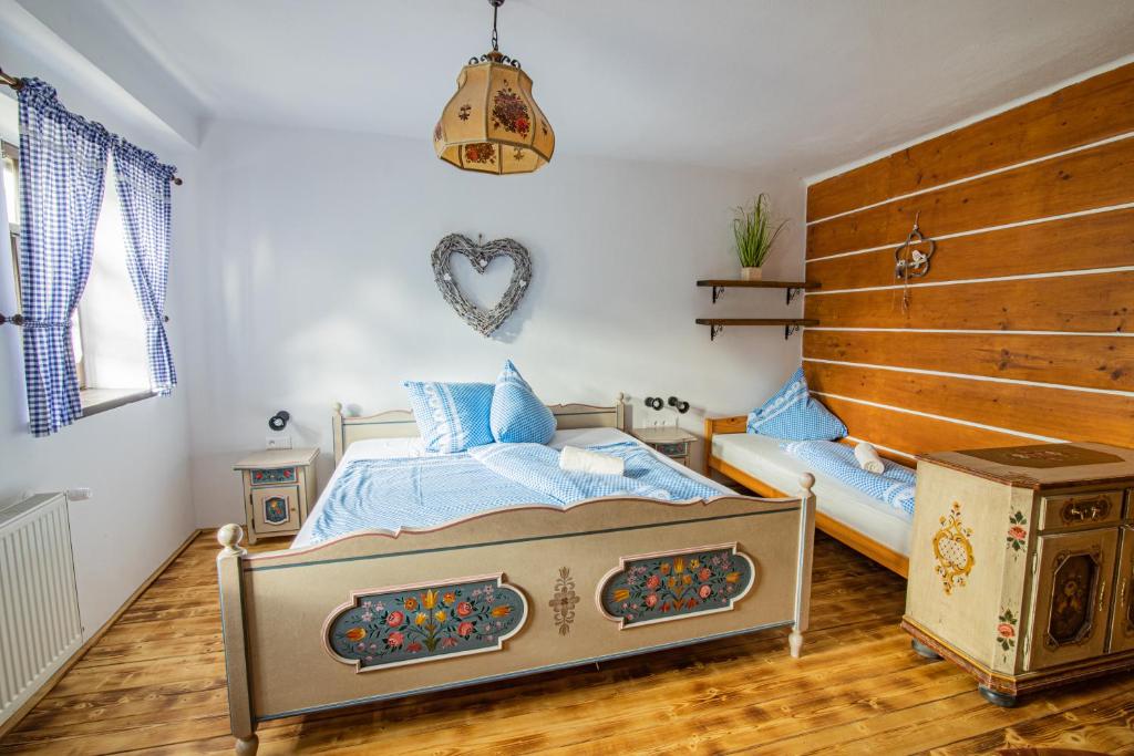 a bedroom with a bed and a large wooden headboard at Penzion Sněžná Volary in Volary