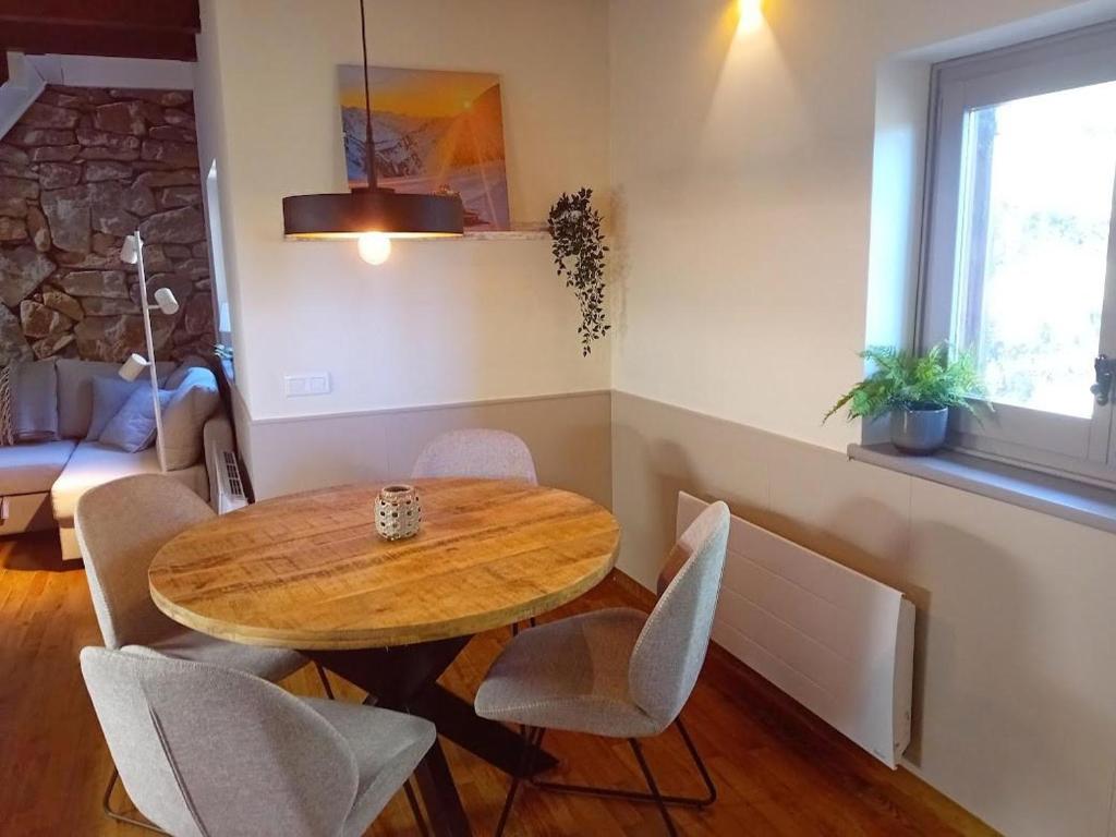 comedor con mesa de madera y sillas en Apartamento PinosPenthouse pie de pistas La Molina, en La Molina