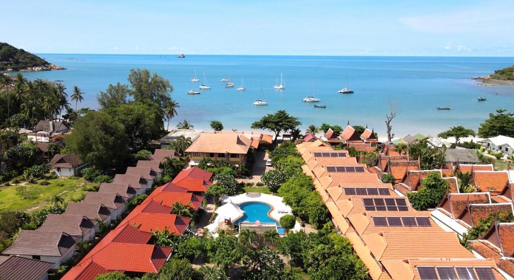 an aerial view of a resort with boats in the water at PS Thana Resort in Choeng Mon Beach