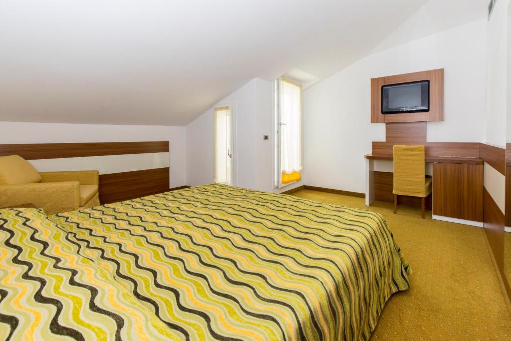 Postel nebo postele na pokoji v ubytování Hotel Maregolf