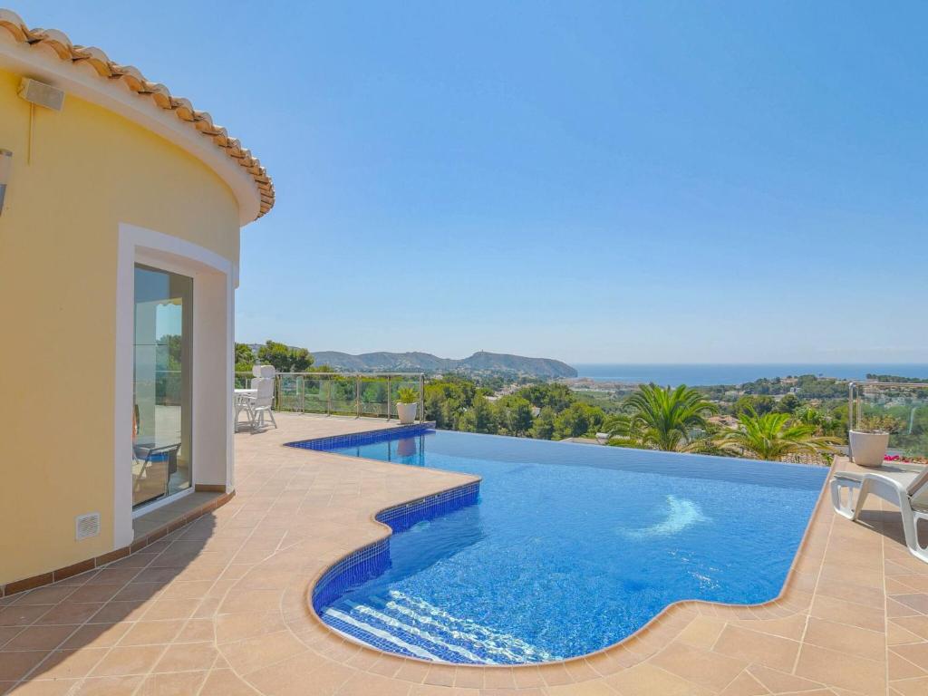 a swimming pool in a villa with a view at Unique villa in Moraira with infinity pool in Moraira