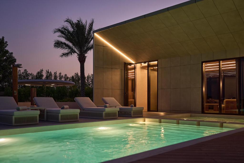a swimming pool in front of a building at ERTH Abu Dhabi Hotel in Abu Dhabi