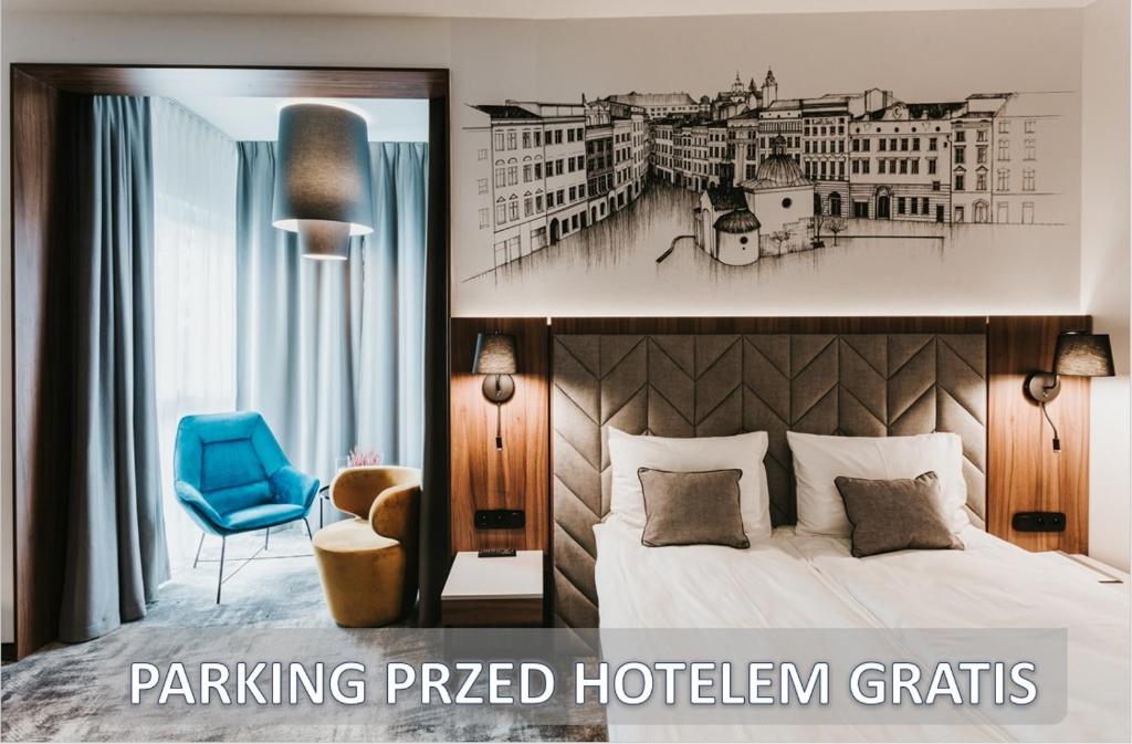 a hotel room with a bed and a blue chair at Garden Square Hotel in Kraków