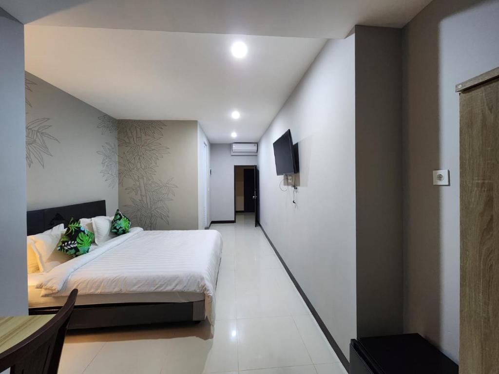 Postel nebo postele na pokoji v ubytování Hepi Yuk Ubud Luxury Guesthouse