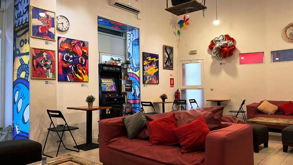 a living room with a red couch in a room at Way Hostel Madrid in Madrid