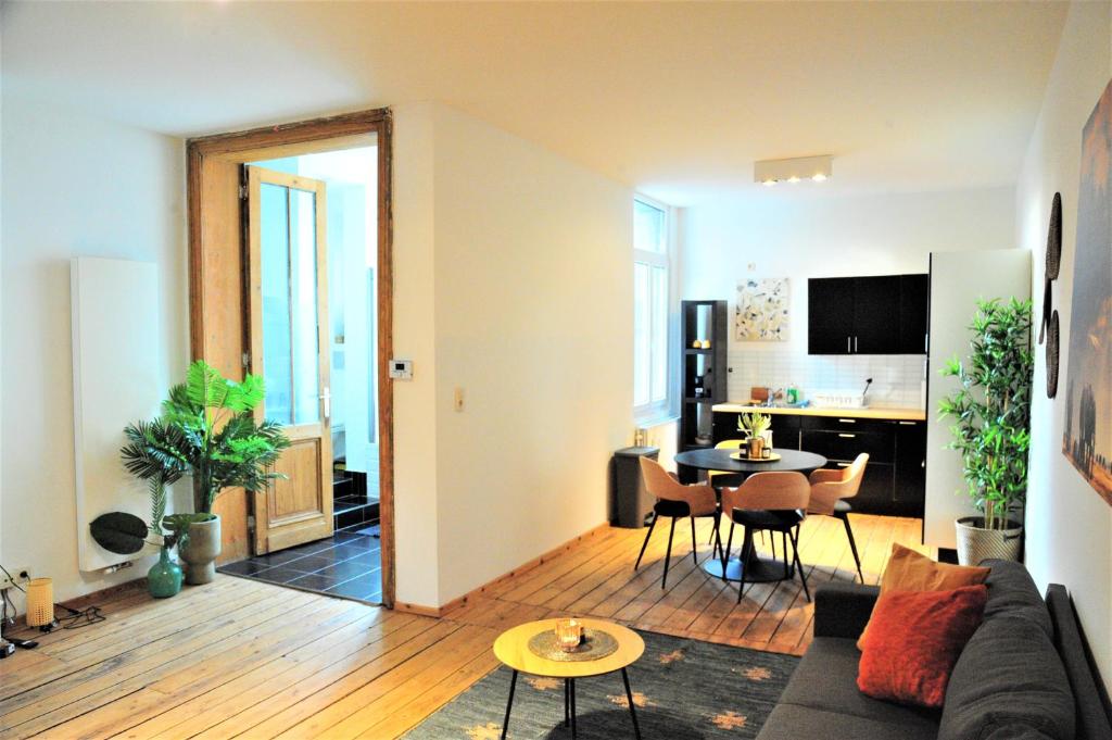 a living room with a couch and a table at The Oasis apartment, 2 bedrooms antwerp South in Antwerp