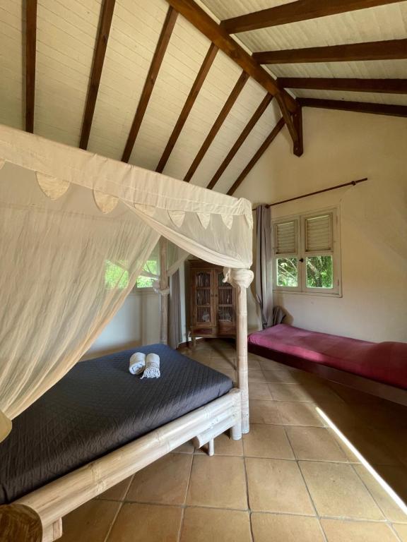Postel nebo postele na pokoji v ubytování Le relais de la montagne Pelée
